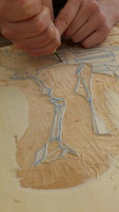 raising fine detail by clearing away most of the wood, this takes time to do well and accurately